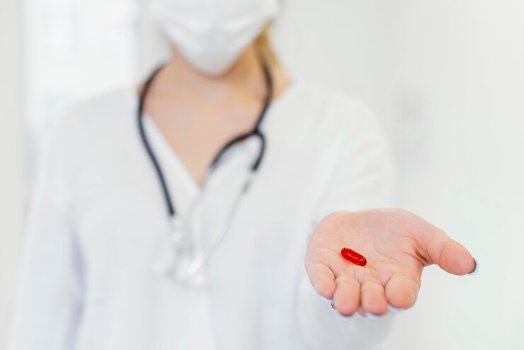 close-up-doctor-holding-pill_23-2148868133