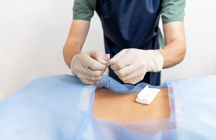 hand-holding-syringe-equipment-surgery-needle-gloved-hands_116317-27002